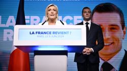 TOPSHOT - French far-right Rassemblement National (RN) party leader Marine Le Pen (L) addresses militants as party President Jordan Bardella listens after French President announced he is calling for new general elections on June 30, during an evening gathering on the final day of the European Parliament election, at the Pavillon Chesnaie du Roy in Paris, on June 9, 2024. (Photo by JULIEN DE ROSA / AFP) (Photo by JULIEN DE ROSA/AFP via Getty Images)