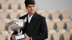 Spain's Carlos Alcaraz poses with his trophy a day after winning the French Open tennis tournament at the Roland Garros Complex in Paris, on June 10, 2024. Carlos Alcaraz fought back to defeat Alexander Zverev in a five-set French Open final on June 9 and become the youngest man to win Grand Slam titles on all three surfaces. (Photo by Dimitar DILKOFF / AFP) (Photo by DIMITAR DILKOFF/AFP via Getty Images)