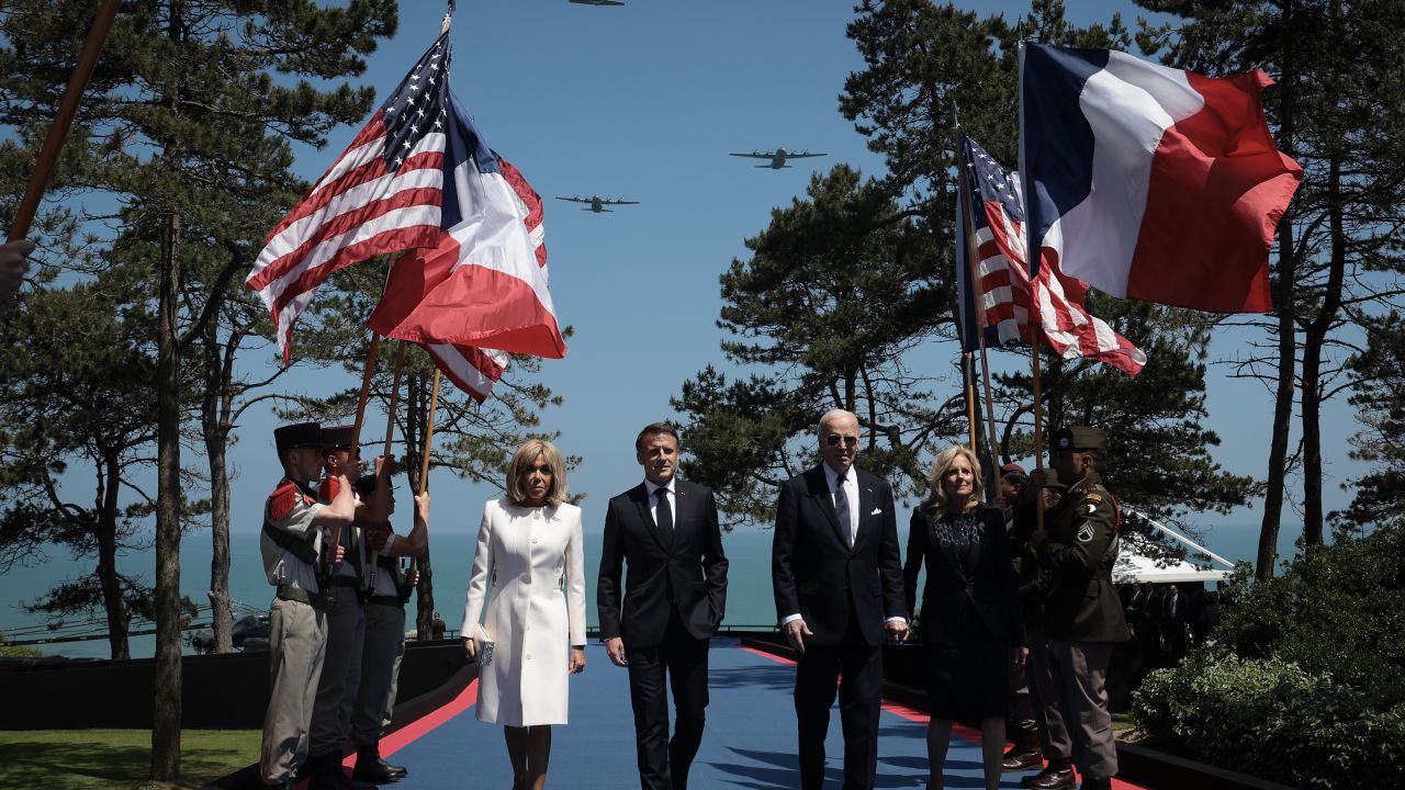 COLLEVILLE-SUR-MER, FRANCE - JUNE 06: U.S. President Joe Biden and first lady Jill Biden walk with French President Emmanuel Macron and his wife Brigitte Macron while arriving at a ceremony marking the 80th anniversary of D-Day at the Normandy American Cemetery on June 06, 2024 in Colleville-sur-Mer, France. Veterans, families, political leaders and military personnel are gathering in Normandy to commemorate D-Day, which paved the way for the Allied victory over Germany in World War II. (Photo by Win McNamee/Getty Images)