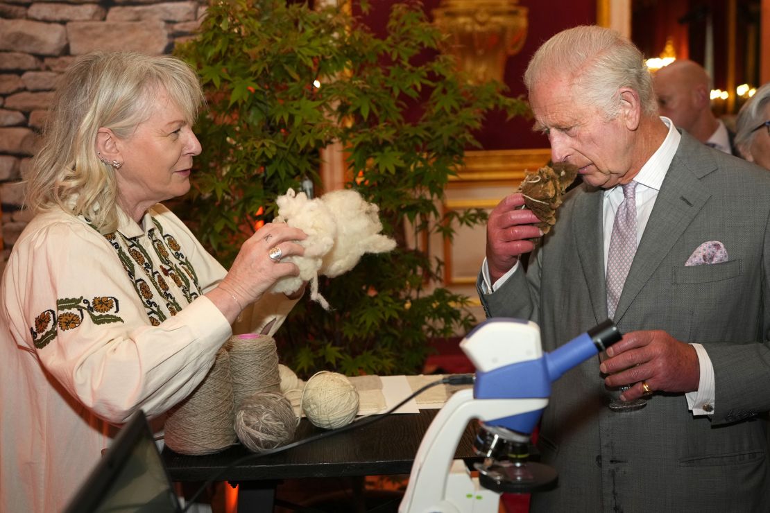 King Charles III smells a wool sample at the King's Foundation awards.