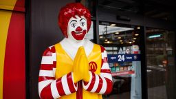 A Ronald McDonald poses with a traditional Thai "wai" greeting at the entrance to a McDonald's restaurant in Central Bangkok on June 08, 2024 in Bangkok, Thailand.