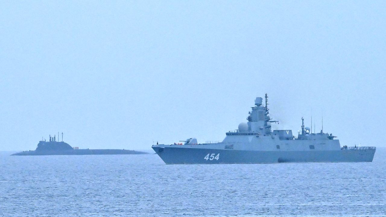The Russian nuclear-powered submarine Kazan (L) and the class frigate Admiral Gorshkov, part of the Russian naval detachment visiting Cuba, arrive at Havana's harbour, June 12, 2024. The Russian nuclear-powered submarine Kazan -- which will not be carrying nuclear weapons -- and three other Russian naval vessels, will dock in the Cuban capital from June 12-17. The unusual deployment of the Russian military so close to the United States -- particularly the powerful submarine -- comes amid major tensions over the war in Ukraine, where the Western-backed government is fighting a Russian invasion. (Photo by ADALBERTO ROQUE / AFP) (Photo by ADALBERTO ROQUE/AFP via Getty Images)