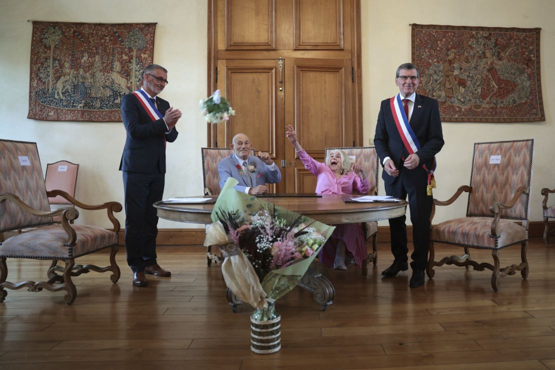 Harold Terens watches his bride toss a bouquet of flowers following their wedding at the Carentan-les-Marais Town Hall on June 8, 2024.