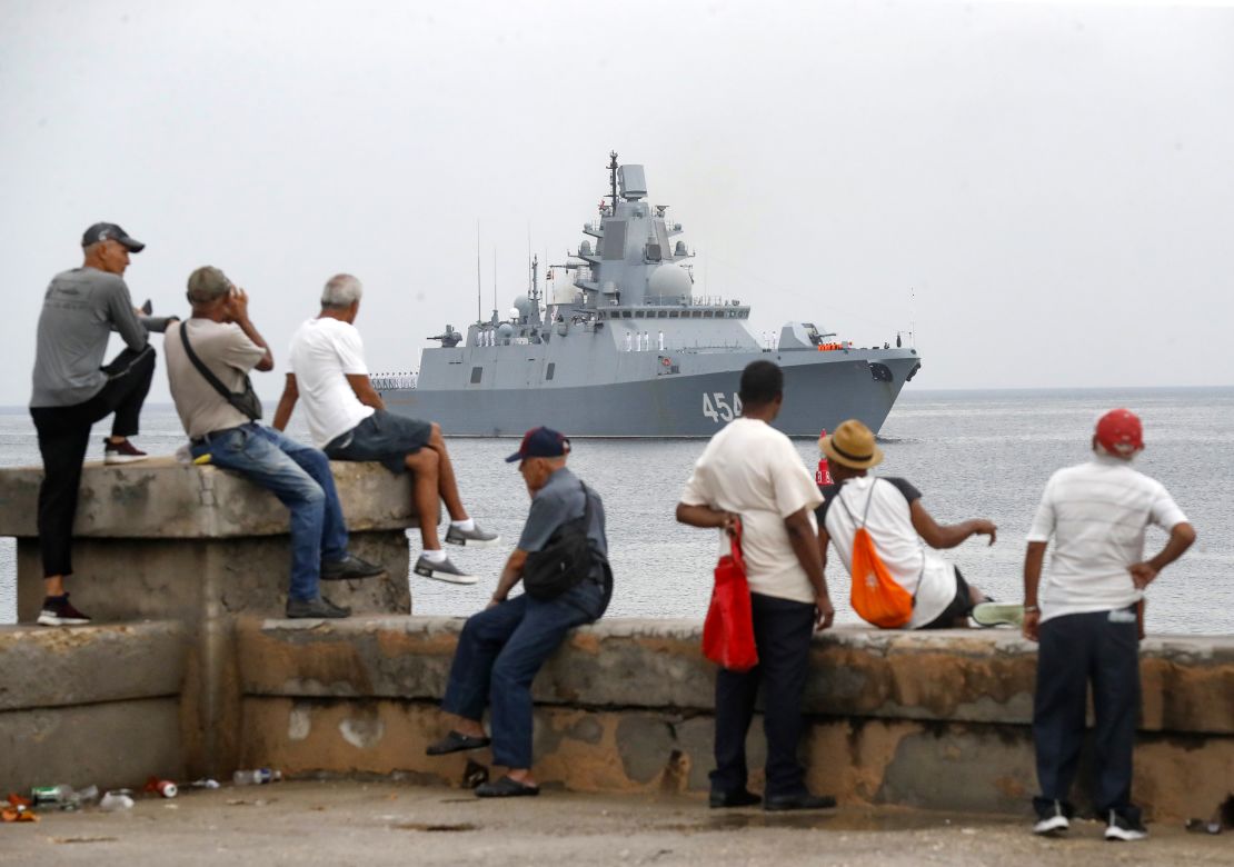 People watch a ship belonging to the Russian Navy flotilla arrive at the port of Havana on Wednesday, June 12, 2024, in Havana, Cuba.