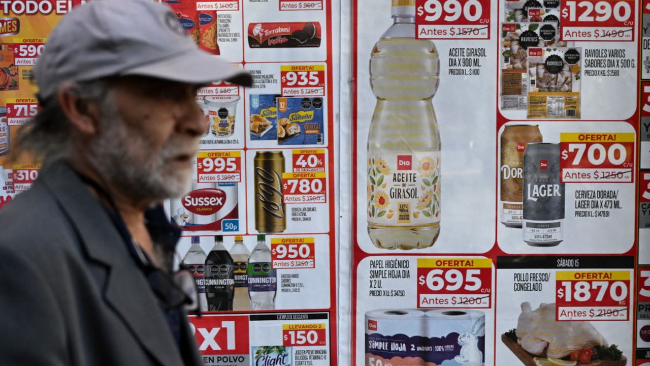 A man walks past food price signs on a street in Buenos Aires on June 13, 2024. Monthly inflation in economic crisis-riddled Argentina came in at 4.2 percent in May, the lowest in two-and-a-half years, mainly due to a drop in domestic consumption, and interannual inflation stands at 276.4%, the INDEC statistics agency said on June 13, 2024. (Photo by LUIS ROBAYO / AFP) (Photo by LUIS ROBAYO/AFP via Getty Images)