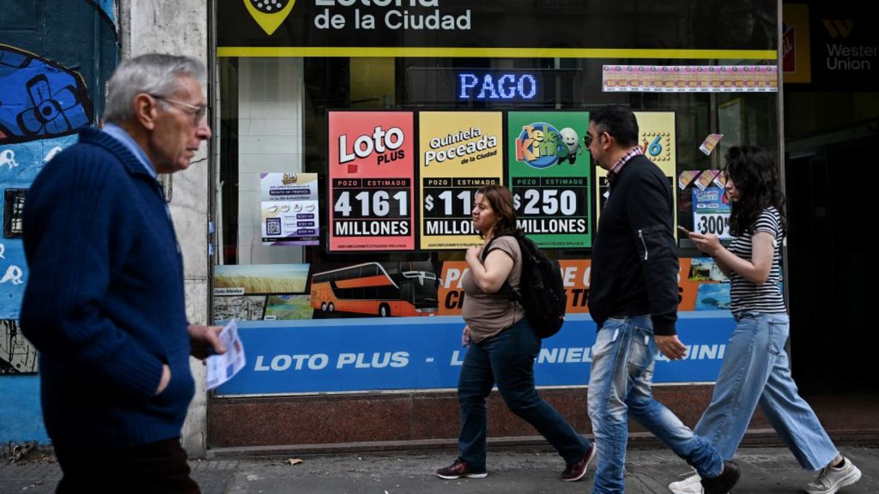 People walk next to a lottery sale on a street in Buenos Aires on June 13, 2024. . Monthly inflation in economic crisis-riddled Argentina came in at 4.2 percent in May, the lowest in two-and-a-half years, mainly due to a drop in domestic consumption, and interannual inflation stands at 276.4%, the INDEC statistics agency said on June 13, 2024. (Photo by LUIS ROBAYO / AFP) (Photo by LUIS ROBAYO/AFP via Getty Images)