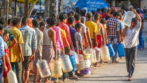People filling water from a supply water tanker of Delhi Government, during a high temperature heat wave, at Chilla Village Near Mayur Vihar, on June 13, 2024 in New Delhi, India.