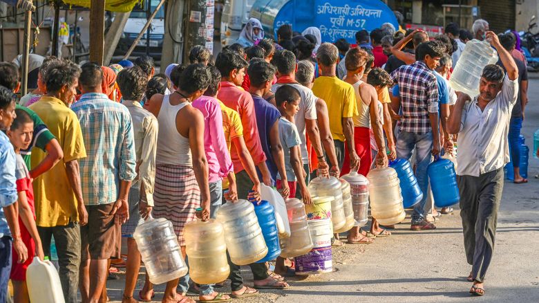 People filling water from a supply water tanker of Delhi Government, during a high temperature heat wave, at Chilla Village Near Mayur Vihar, on June 13, 2024 in New Delhi, India.