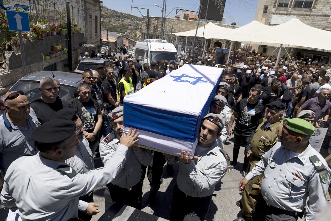 Soldiers carry the coffin of an Israeli Captain who was killed in fighting in southern Gaza, during his funeral in Beit Jann, Israel, on June 16, 2024.