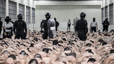 TECOLUCA, EL SALVADOR - JUNE 11: In this handout picture provided by the Salvadoran presidency Police officers guard inmates as 2,000 detainees are moved to mega- prison Terrorist Confinement Centre (CECOT) on June 11, 2024 in Tecoluca, El Salvador. Since president Bukele announced a state of exception in March 2022, over 80,000 suspected gang  have been arrested. Human Rights organizations denounce abuses and due process violations. El Salvador has one of highest crime rates in Latin America. (Photo by Handout/Presidencia El Salvador via Getty Images )