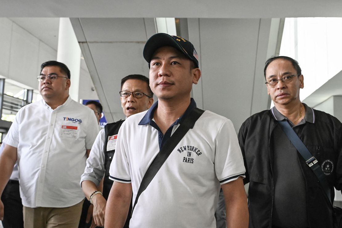 Christian Domarique (center), a crew member of the MV Tutor, arrives in Metro Manila, on June 17. Dozens of ships have been attacked in the Red Sea, as regional tensions flare over Israel's war in Gaza.