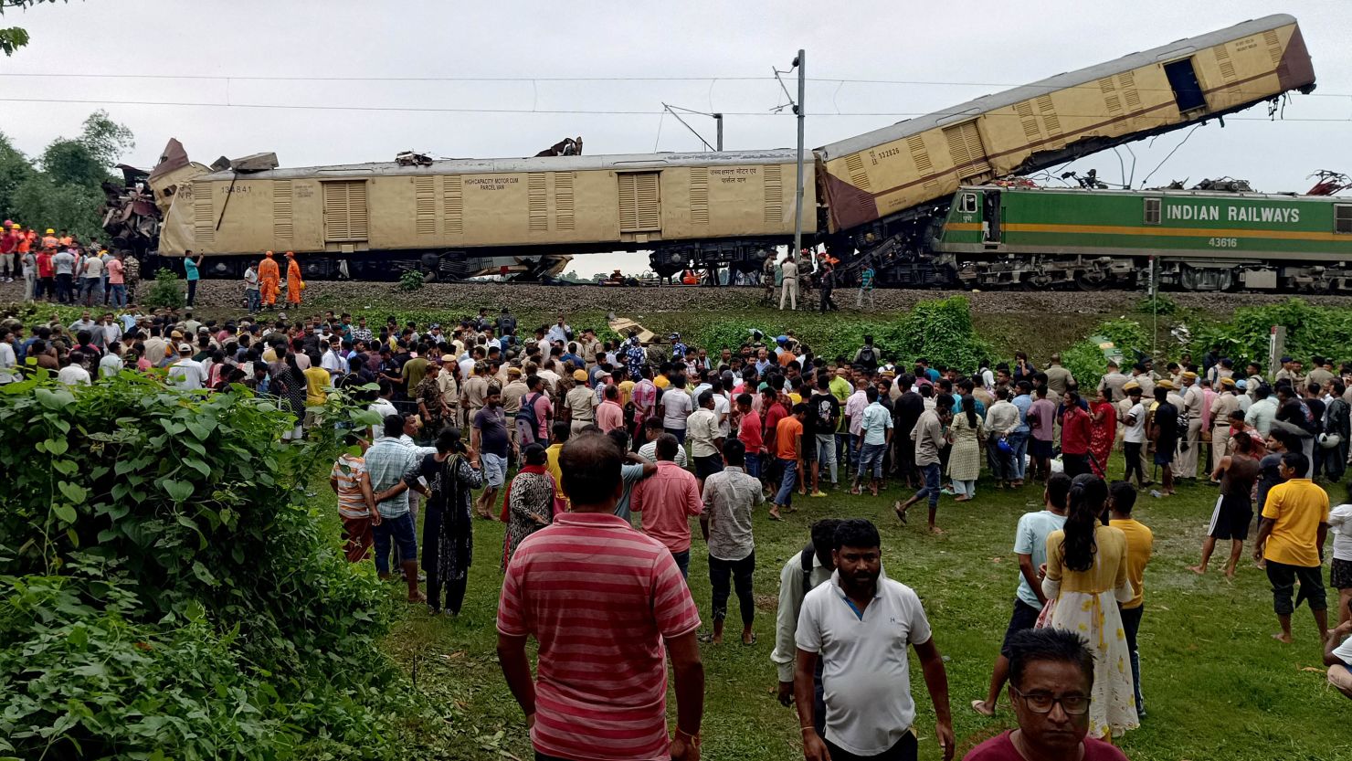 People gather at the site of a train collision in Nirmaljote, in India's West Bangal state, on June 17.