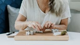 Senior woman rolling a joint