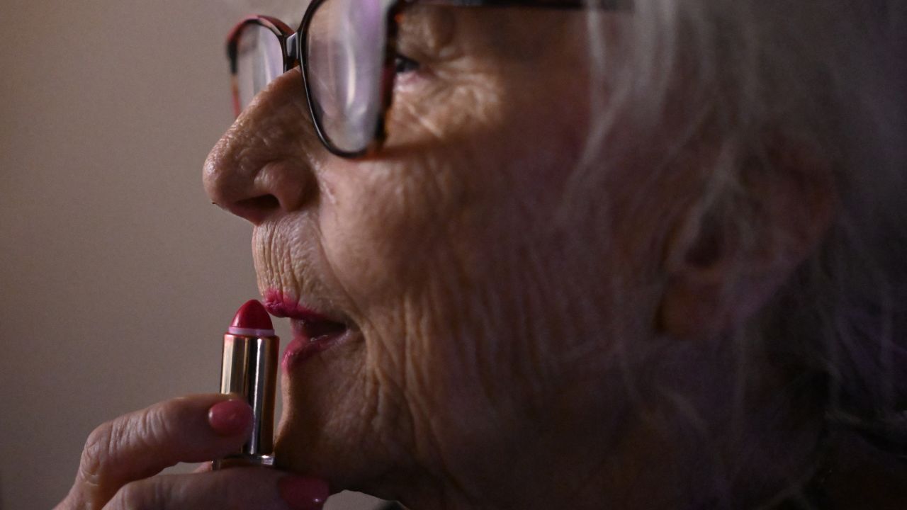 Polish activist Wirginia Szmyt, 85, also known as DJ Wika, puts on lipstick following her performance at a bar in Warsaw on April 6, 2024. 85-year-old Wirginia Szmyt is a Polish DJ who gained fame for being one of the oldest DJs in the world. She started her DJ career in her seventies, bringing energy and ion to the dance floors primarily for senior citizens. Aiming to break myths about old age, DJ Wika is modern in more ways than one, being a staunch er of women's rights, pensioners, and the LGBTQ community. Aside from her regularly-scheduled gigs at the shopping centre in Warsaw, her performance venues include festivals for gender equality, pride parades, and charity events in of children with cancer around the world. (Photo by Sergei GAPON / AFP) (Photo by SERGEI GAPON/AFP via Getty Images)
