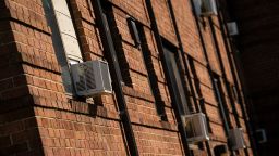 Air conditioning units installed in windows at an apartment complex in Hyattsville, Maryland, on Monday, June 17, 2024. While summer doesn't officially start until Thursday, across the US more than 120 daily high temperature records may be broken or tied, with the majority of them in the Midwest, Mid-Atlantic and New England, the US Weather Prediction Center said.