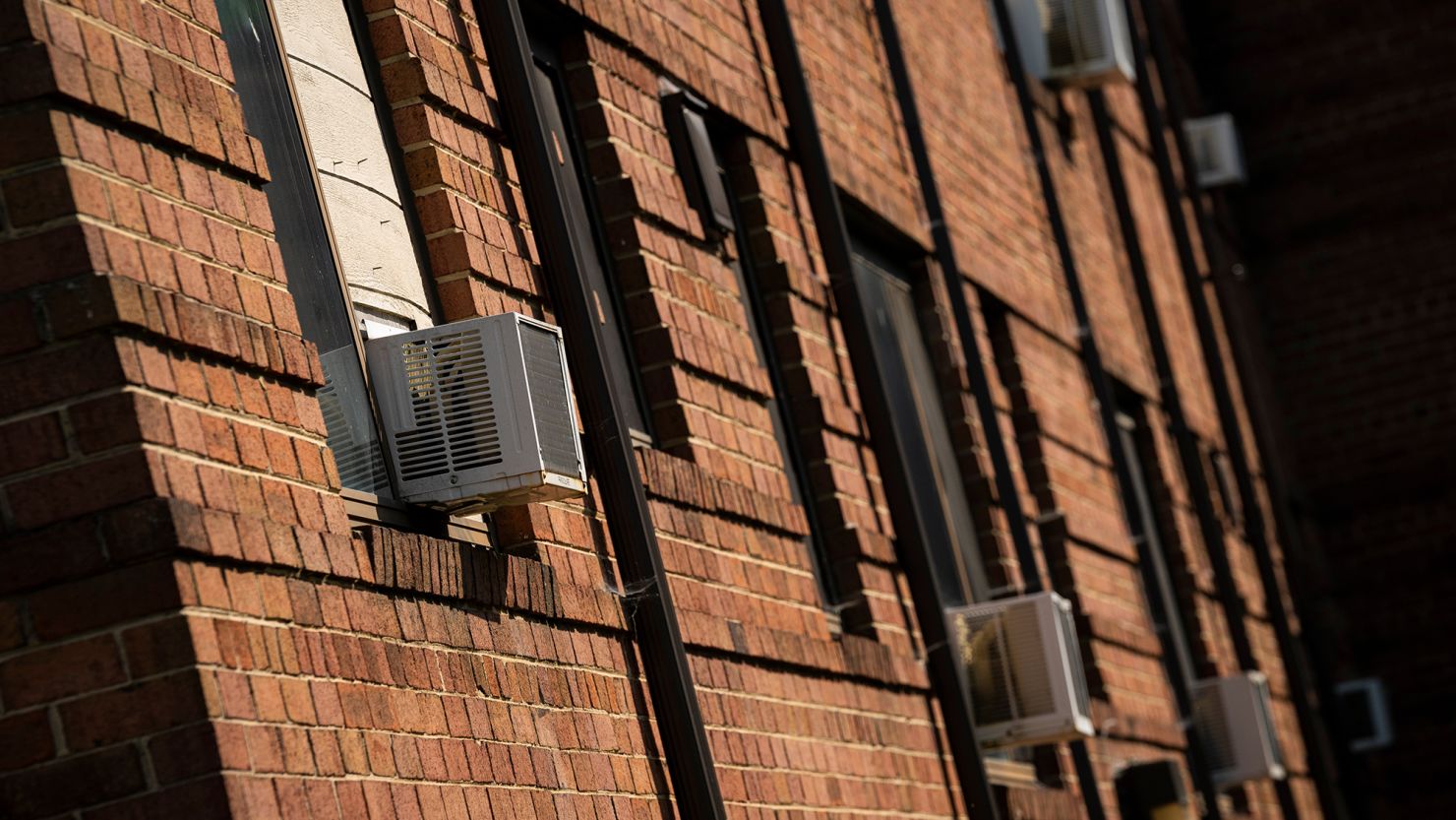 Air conditioning units installed in windows at an apartment complex in Hyattsville, Maryland, on Monday, June 17, 2024.