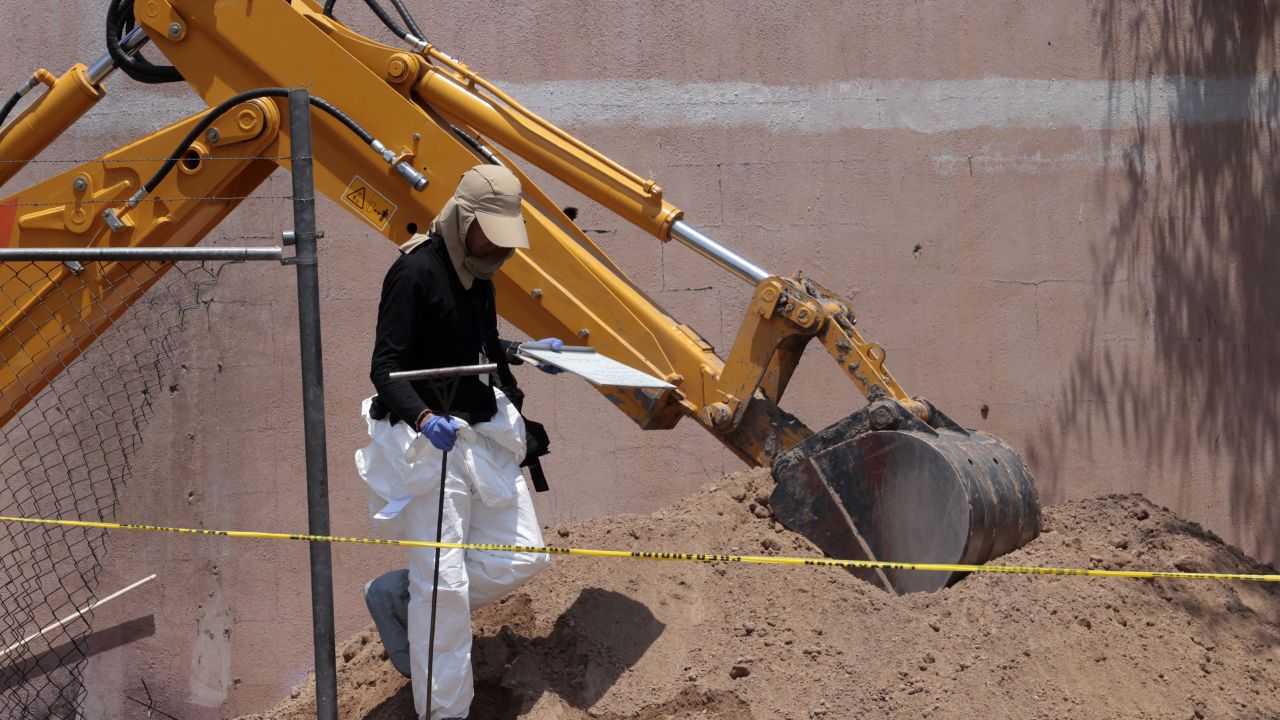 A forensic expert walks next to a clandestine grave in Tlajomulco, Jalisco State, Mexico, on June 17, 2024. At least 10 bodies buried in a clandestine grave in western Mexico have been exhumed since June 14, the leader of a collective searching for the disappeared told AFP. (Photo by ULISES RUIZ / AFP) (Photo by ULISES RUIZ/AFP via Getty Images)