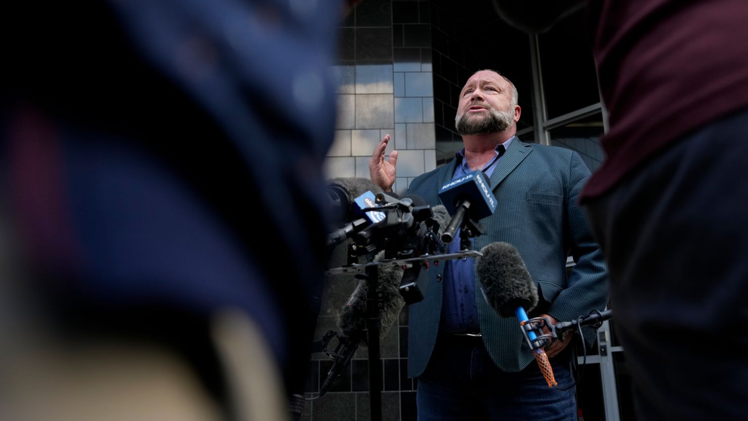Right-wing conspiracy theorist Alex Jones speaks to the press before his bankruptcy hearing Friday, June 14, 2024 at Bob Casey Federal Courthouse in Houston.