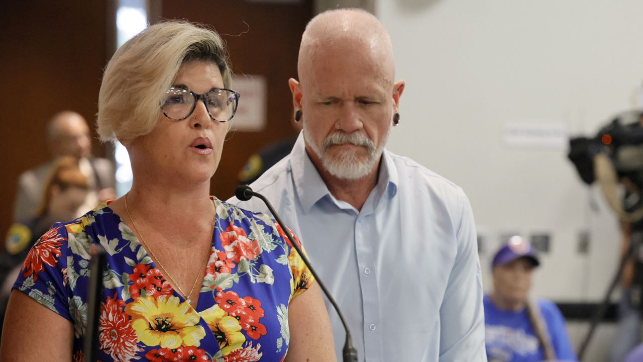 Jessica Norton, with her husband, Gary, speaks during the public comment period at a Broward County School Board meeting in Fort Lauderdale held on Tuesday, June 18, 2024. Norton, whose daughter played on the Monarch High School volleyball team, was one of five Monarch officials removed from the school Nov. 27 amid an inquiry into possible violations of the "Fairness in Women's Sports Act," a 2021 law that bans transgender girls from playing on girls' sports teams. Norton is the only one facing potential discipline. (Amy Beth Bennett/South Florida Sun Sentinel/Tribune News Service via Getty Images)