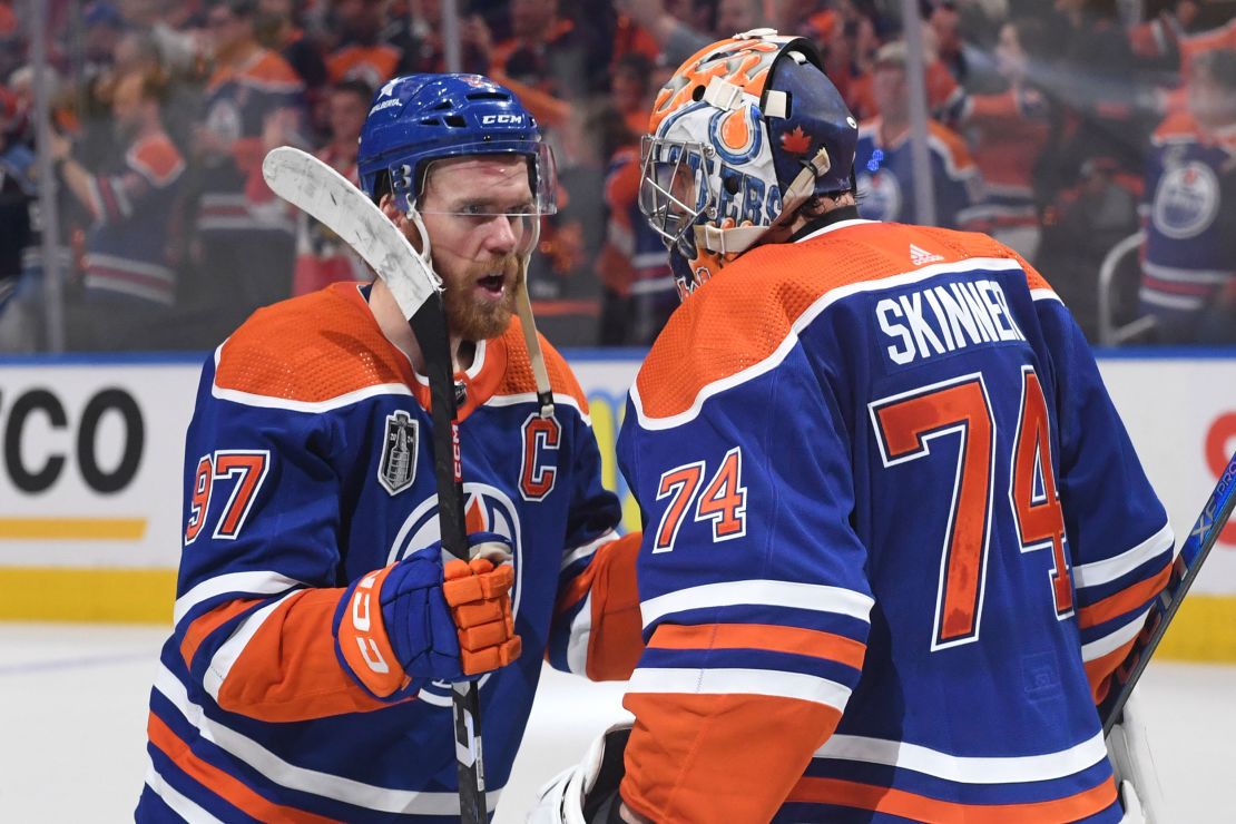 McDavid (left) celebrates with Oilers goaltender Stuart Skinner (right) after Edmonton's victory in Game 4.