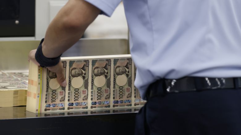 An employee handles sheets of newly-designed Japanese 10,000 yen banknotes at the National Printing Bureau Tokyo plant in Tokyo, Japan, on Wednesday, June 19, 2024. Persistent weakness in the yen is raising concerns about the potential for a resurgence in cost-push inflation, likely weighing on private consumption. Photographer: Kiyoshi Ota/Bloomberg