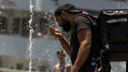 A person cools off in a water fountain by the Hudson River as a heat wave hits the northeast US on June 20, 2024 in New York. Most of the United States will experience hotter than normal weather throughout the summer, from July to September, a US government agency predicted Thursday, as a large part of the country sizzled in the first heat wave of the year. (Photo by Yuki IWAMURA / AFP)