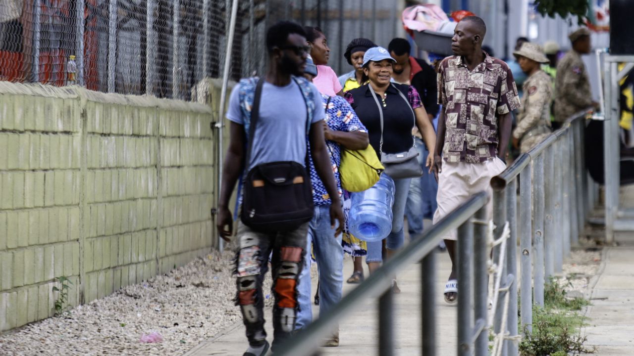 Haitian citizens cross the border between Anse-à-Pitres in Haiti and Pedernales in the Dominican Republic on June,20 2024. (Photo by Erickson POLANCO / AFP) (Photo by ERICKSON POLANCO/AFP via Getty Images)