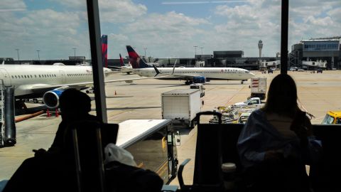 Passengers wait before boarding as an Airbus A321 passenger aircraft of Delta Airlines moves along the tarmac at Hartsfield-Jackson Atlanta International Airport in Atlanta, Georgia on June 21, 2024. (Photo by Charly TRIBALLEAU / AFP)