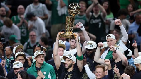 The Celtics' Jayson Tatum lifts the the Larry O’Brien Championship Trophy after Boston's 106-88 win against the Dallas Mavericks in Boston on Monday night.