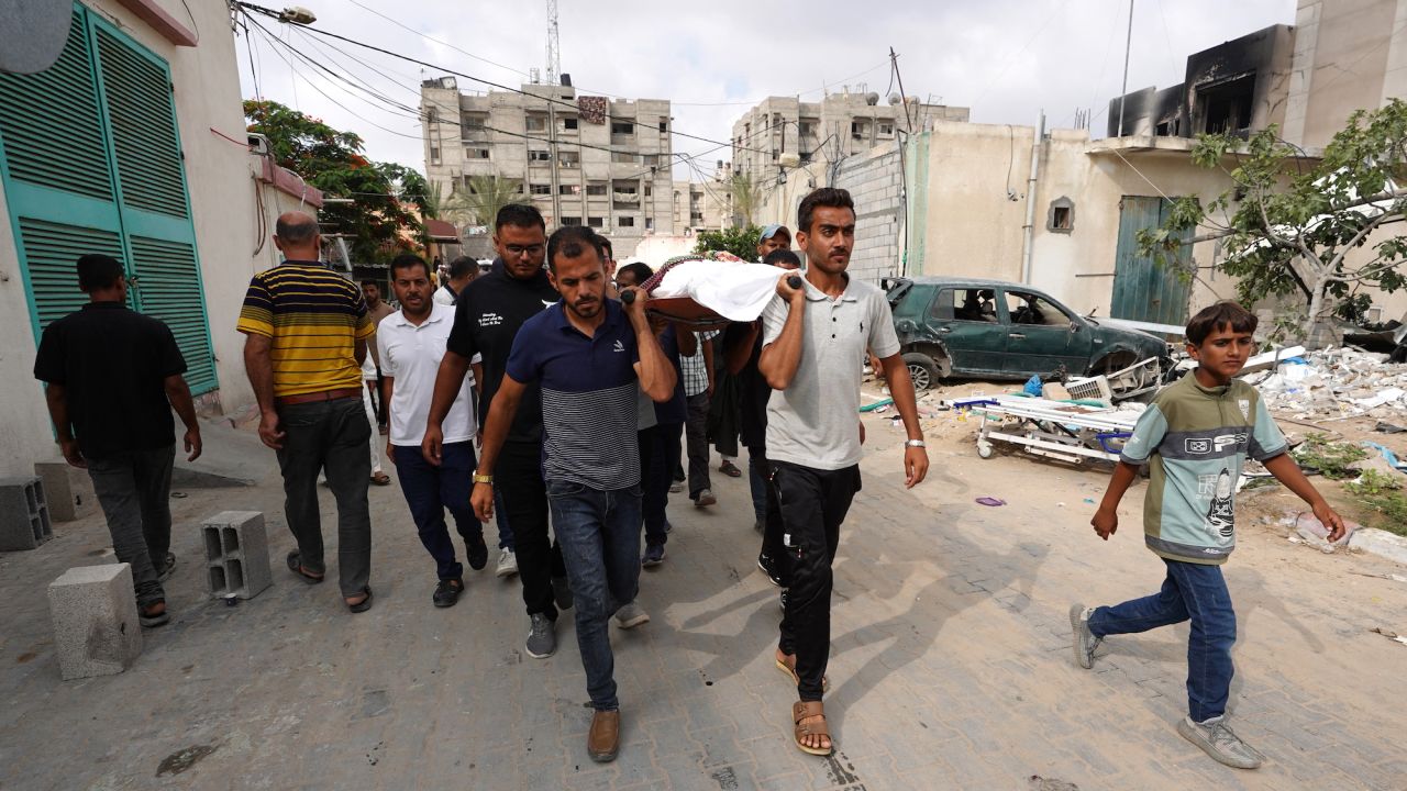 Palestinian men carry a civilian killed by the strike on Mawasi in southern Gaza, on June 22.