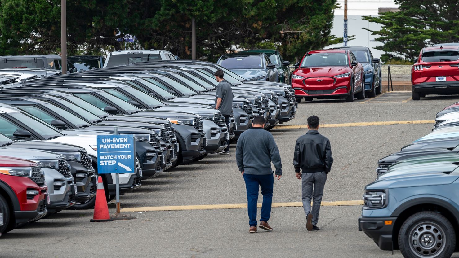 Customers view used Ford vehicles at a dealership in Colma, California, on June 21, 2024.