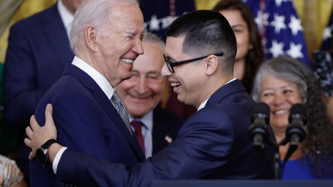 WASHINGTON, DC - JUNE 18: U.S. President Joe Biden is embraced by Javier Quiroz Castro after Castro introduced him before delivering remarks at an event marking the 12th anniversary of the Deferred Action for Childhood Arrivals (DACA) program in the East Room at the White House on June 18, 2024 in Washington, DC. Biden announced a new program that will provide protections for undocumented immigrants married to U.S. citizens, allowing them to obtain work authorization and streamline their path to citizenship. (Photo by Kevin Dietsch/Getty Images)