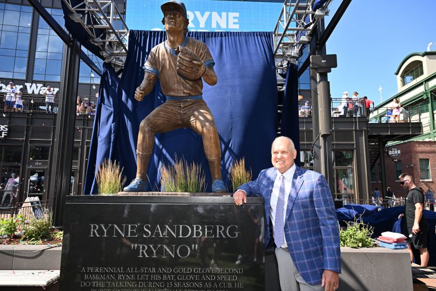 Sandberg poses for pictures in front of his statue at Wrigley Field in June 2024.