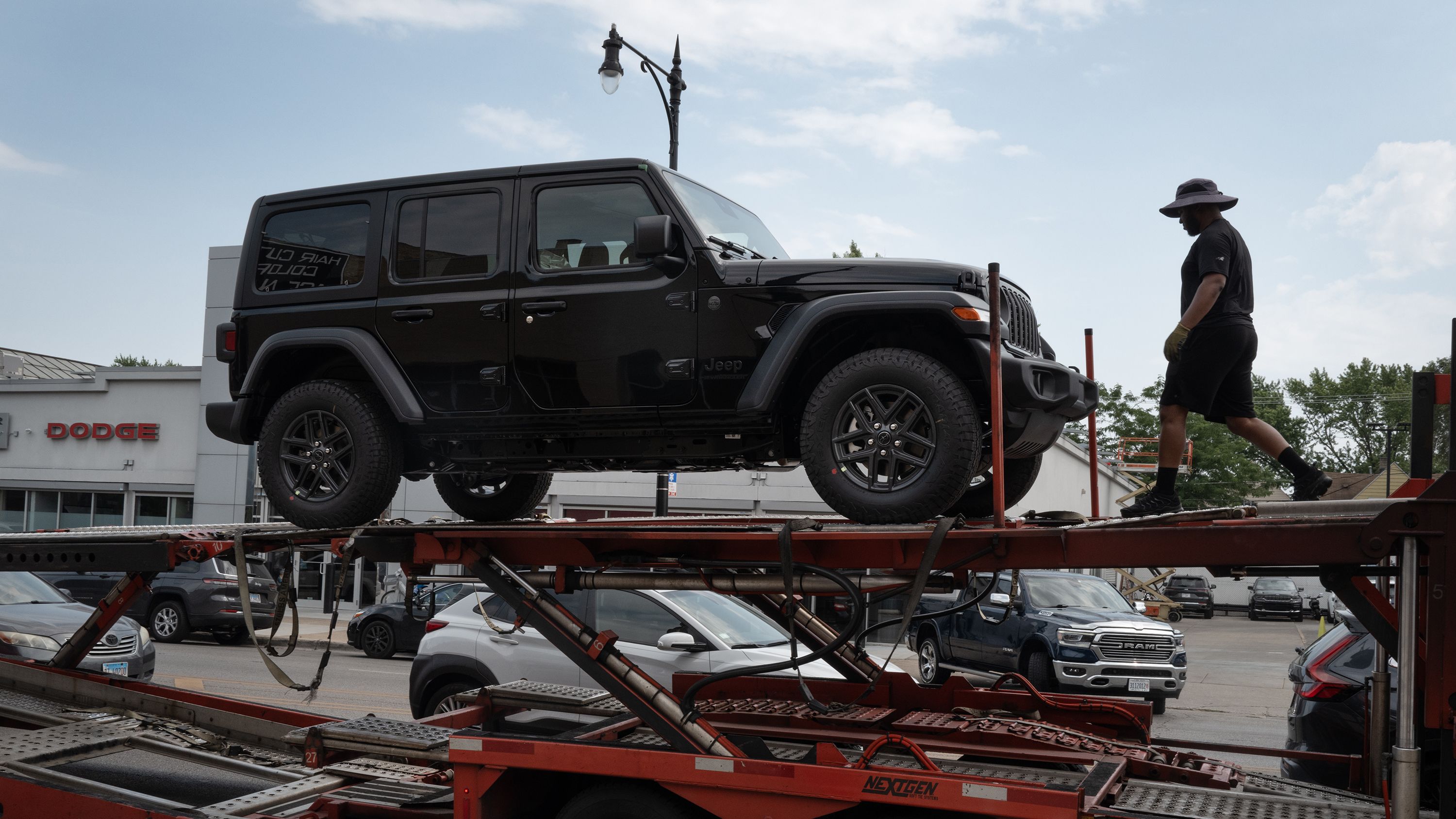 Jeep vehicles are delivered to a dealership on June 20 in Chicago.