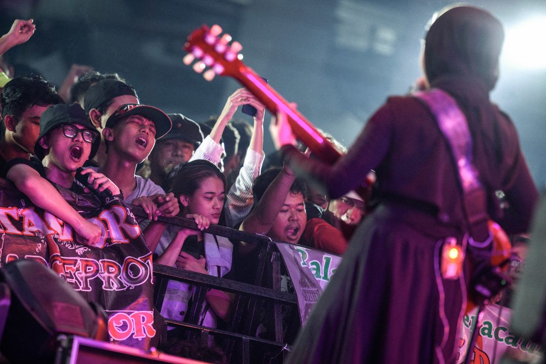 Fans go wild as VOB vocalist and guitarist Firda Kurnia performs on stage during a concert in Jakarta.