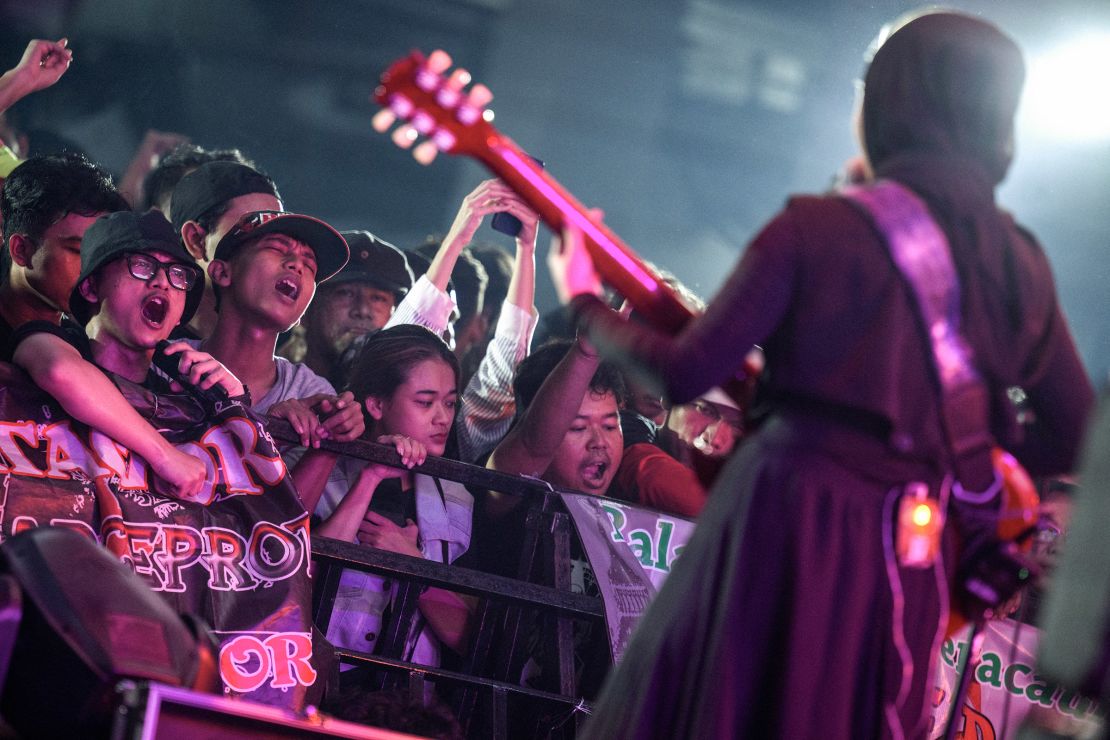 Fans go wild as VOB vocalist and guitarist Firda Kurnia performs on stage during a concert in Jakarta.