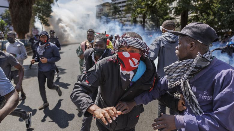 Protesters retreat from a cloud of tear gas during a nationwide strike to protest against tax hikes and the Finance Bill 2024 in downtown Nairobi, on June 25, 2024.