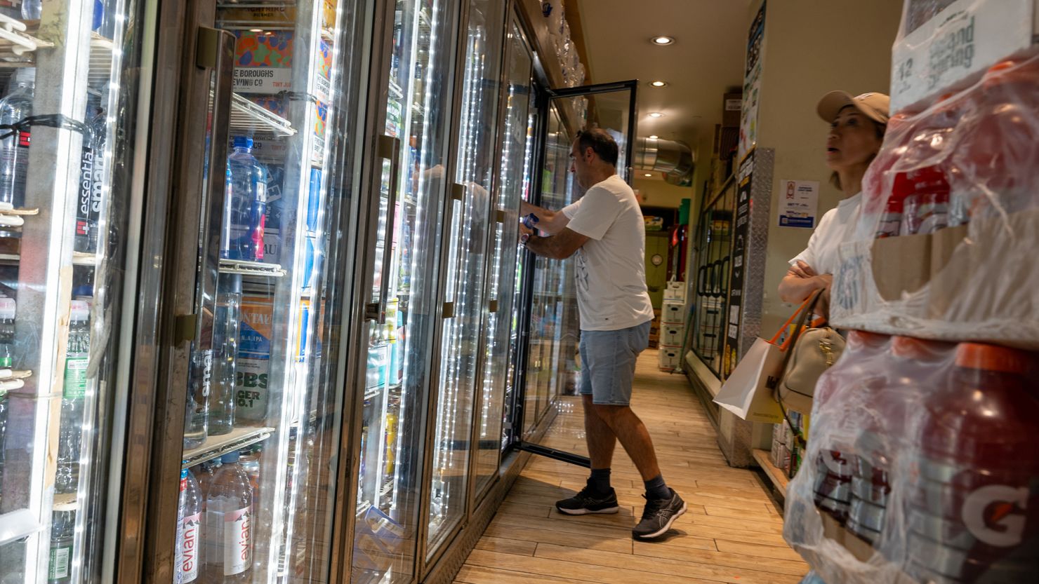 People purchase drinks in a store on a sweltering afternoon in Brooklyn on the first day of summer on June 21, 2024, in New York City.