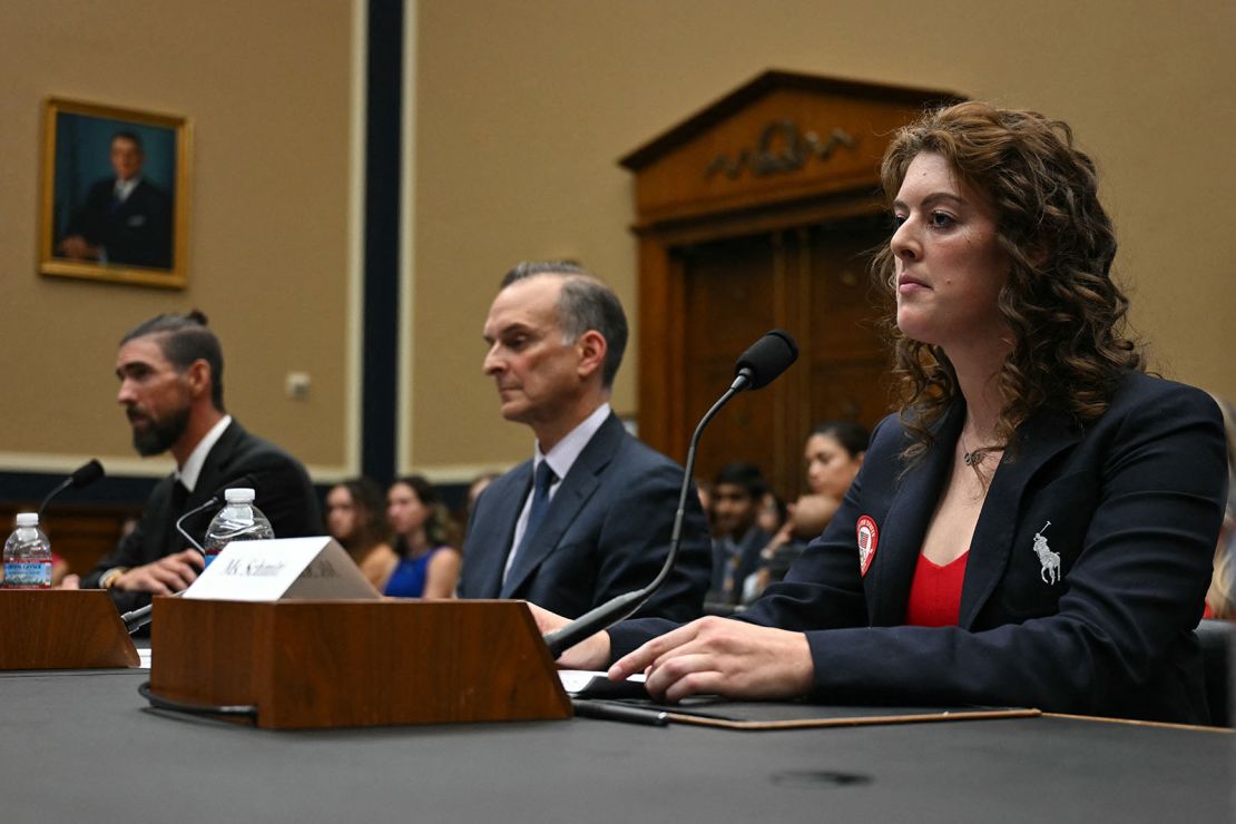 Former Olympians Michael Phelps, left, and Allison Schmitt, right, and US Anti-Doping Agency CEO Travis Tygart testify on Capitol Hill on June 25, 2024.