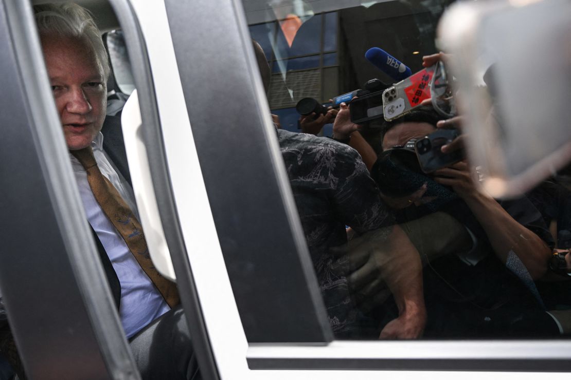 Members of the media surround the vehicle of WikiLeaks founder Julian Assange as he leaves the US Federal Courthouse in Saipan, Northern Mariana Islands, June 26, 2024.