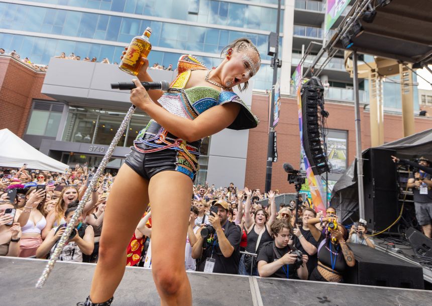 JoJo Siwa takes a swig of Fireball at Chicago Pride last June.