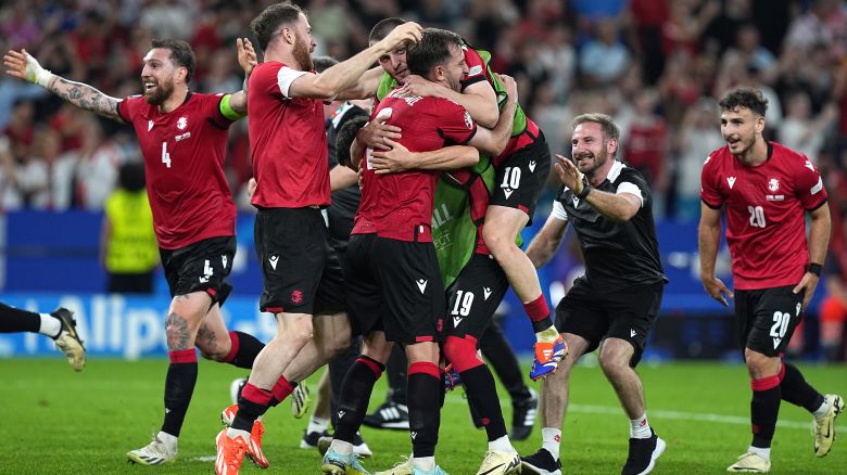 Players of Georgia celebrate their victory at the end of the UEFA Euro 2024 Group F football match between Georgia and Portugal at the Veltins-Arena in Gelsenkirchen, Germany on June 26, 2024.