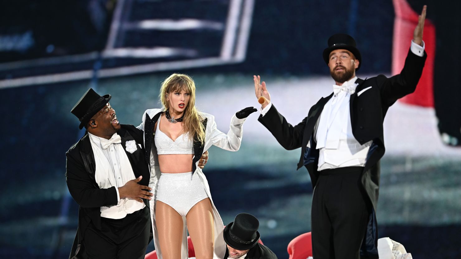Taylor Swift is joined on stage by Travis Kelce, right, during The Eras Tour at Wembley Stadium on June 23 in London.