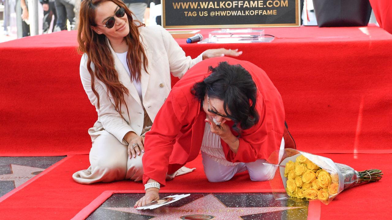 US-Mexican singer songwriter Jenni Rivera's sister Rosie Rivera (L) and mother Rosa Saavedra pose on Jenni' star during her posthumous Walk of Fame ceremony in front of Capitol Records in Hollywood, California, June 27, 2024. (Photo by VALERIE MACON / AFP) (Photo by VALERIE MACON/AFP via Getty Images)