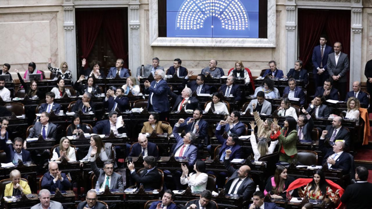 Lawmakers react after approving the "Bases Law" in the Chamber of Deputies of the National Congress in Buenos Aires, early on June 28, 2024. The Argentine Congress granted the first legislative victory to ultra-liberal President Javier Milei early Friday morning by approving his economic reform package, albeit a narrower version than the original one, after months of debates. (Photo by Emiliano Lasalvia / AFP) (Photo by EMILIANO LASALVIA/AFP via Getty Images)