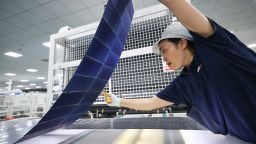 An employee works on the production line of solar panels for export overseas at a workshop of a new energy enterprise on June 24, 2024 in Lianyungang, Jiangsu Province of China.