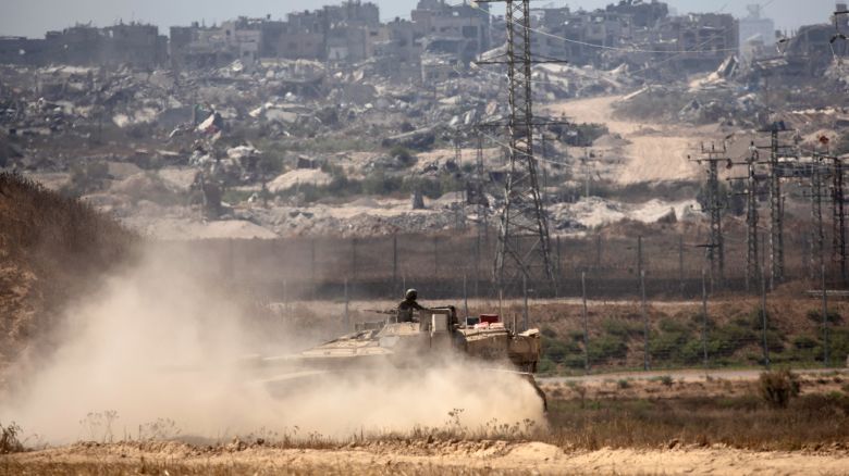 An Israeli soldier stands on a tank as it is driven near the border with the Gaza Strip as seen from a position on the Israeli side of the border on June 28, 2024 in Southern Israel, Israel. Yesterday, there were reports of a new bombardment of a part of Gaza City, with an incursion by Israeli ground forces. Prime Minister Netanyahu has seemed to further distance himself from a US-backed ceasefire proposal, instead talking about the war in Gaza entering a less "intense phase."