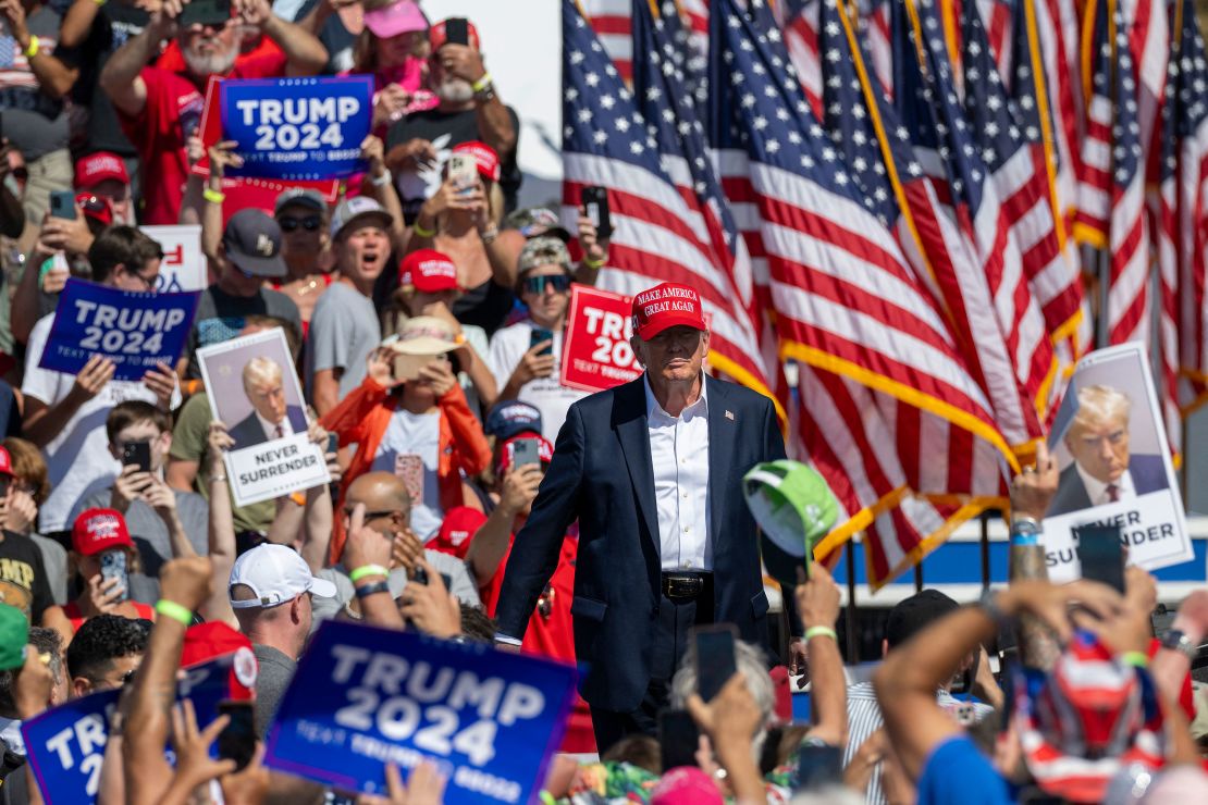 Supporters hold up signs at former President Donald Trump's campaign rally in Virginia on June 28, 2024, one day after his historic debate against President Joe Biden.