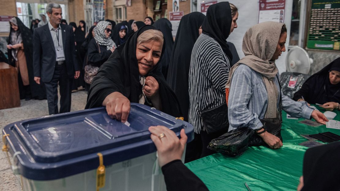 An Iranian woman casts her vote at a polling station during Iran's presidential election, in Tehran, Iran, on Friday.