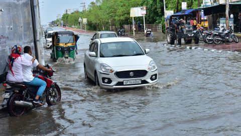 GHAZIABAD, INDIA - JUNE 29: Commuters wade through a waterlogged road during monsoon rainfall at wave city NH9 on June 29, 2024 in Ghaziabad, India. The India Meteorological Department (IMD) predicts heavy to very heavy rainfall in Delhi over the next two days following the city's highest single-day downpour in 88 years on Friday. An 'orange alert' has been issued for Sunday and Monday due to the expected heavy rainfall. (Photo by Sakib Ali/Hindustan Times via Getty Images)